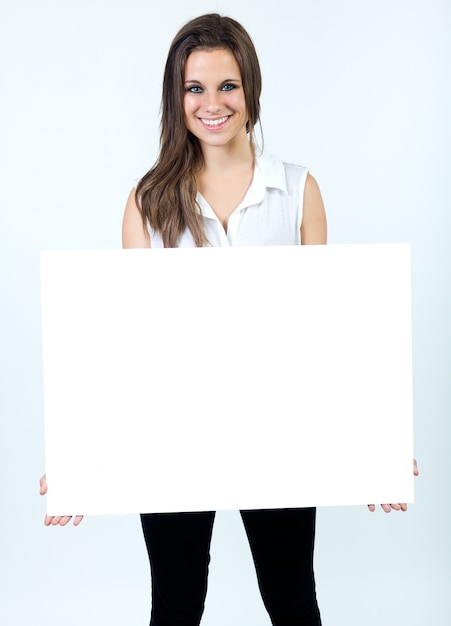 Free photo studio portrait of beautiful young woman posing with white screen