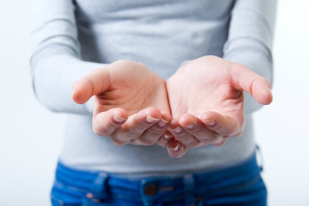 Studio Portrait of beautiful young woman showing her hands