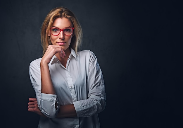 Free Photo studio portrait of blond female dressed in a white shirt and red eyeglasses.