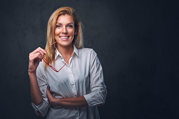 Free Photo studio portrait of blond female dressed in a white shirt and red eyeglasses.