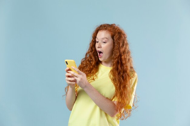 Studio portrait of young woman with red hair