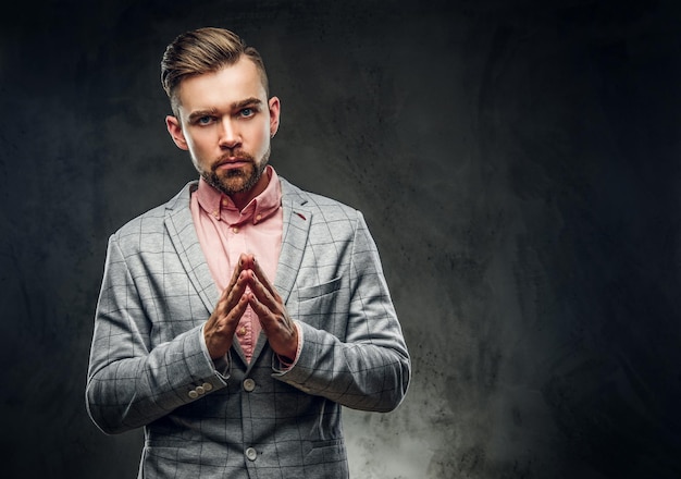 Free photo studio shoot of styilish sceptical man in checkered blaze and pink shirt.