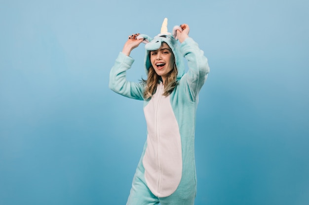 Free photo studio shot of carefree woman in unicorn suit