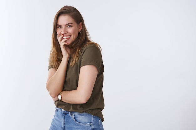 Studio shot charismatic enthusiastic giggling young girlfriend having fun of mocking fooling around laughing out loud standing profile turning camera smiling amused, covering mouth white background