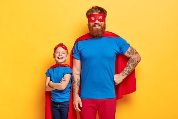 Free photo studio shot of cheerful family in superhero suits