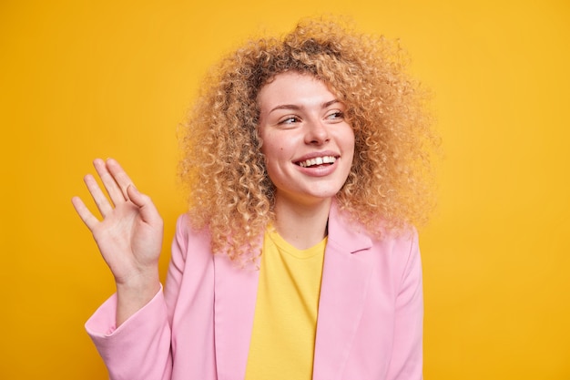 Free Photo studio shot of happy sincere european woman with curly bushy hair 