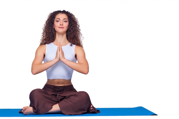 Free photo studio shot of a young woman doing yoga exercises