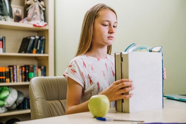 Studying girl with stacked books