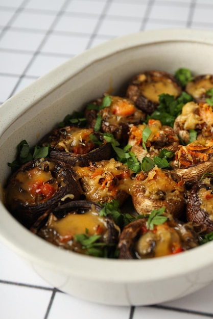 Free Photo stuffed mushrooms in baking tray on light background close up