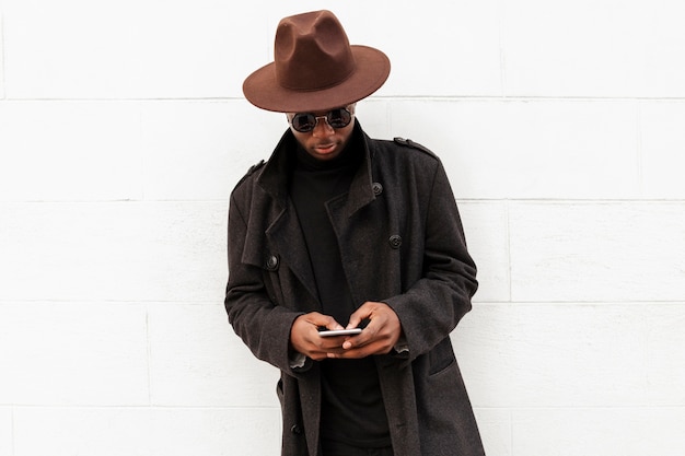 Stylish adult male posing with hat and sunglasses