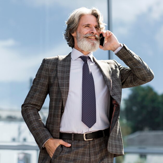 Stylish adult male talking on the phone