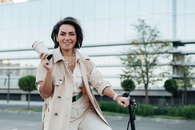 Stylish adult woman posing with eco friendly bike