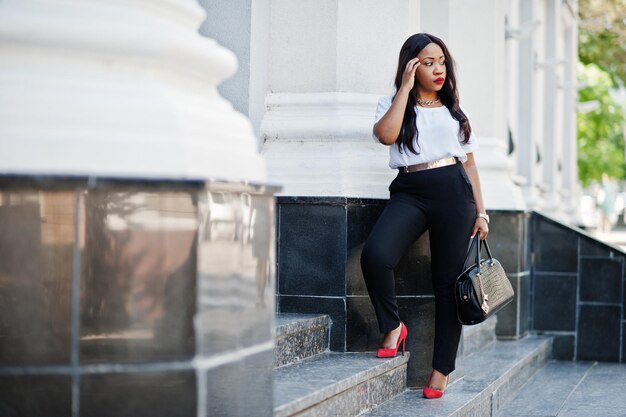 Stylish african american business woman on streets of city