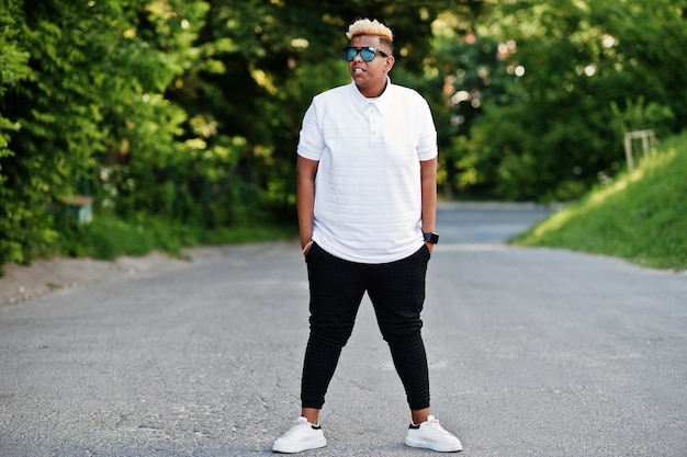 Stylish arabian muslim boy with originally hair and sunglasses posed on streets