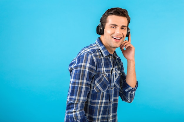 stylish attractive handsome young man listening to music on wireless headphones 