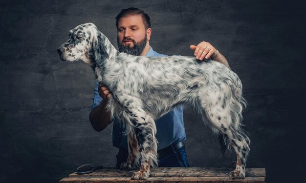 Free Photo stylish bearded middle age male and irish setter.