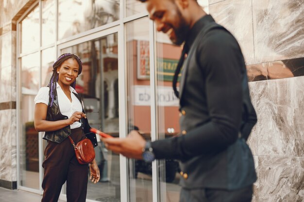 A stylish and beautiful dark-skinned couple in a city