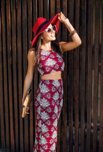 Stylish beautiful woman posing on wooden