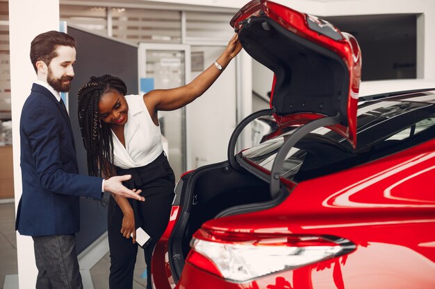 Stylish black woman in a car salon