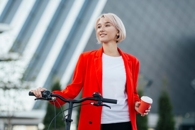 Stylish blonde woman posing outdoors