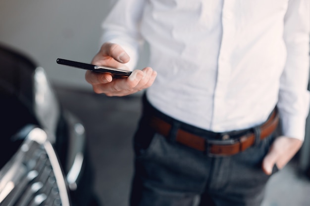 Free Photo stylish businessman working near the car