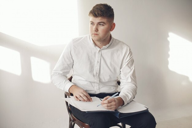 Stylish businessman working in a office and use the phone