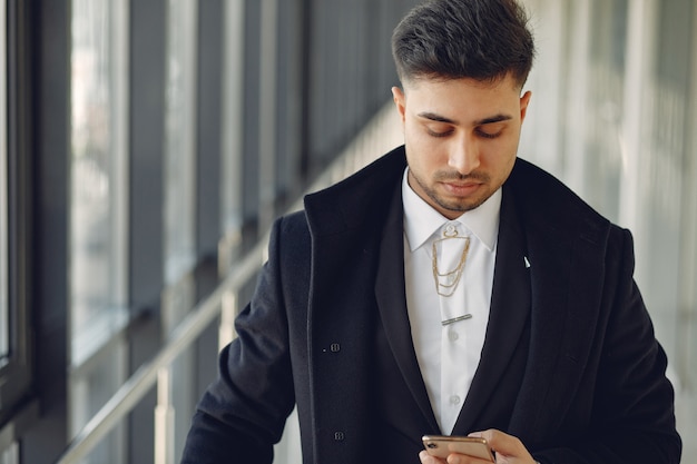 Stylish businessman working in a office and use the phone