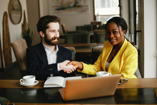 Stylish businessman working in a office with partner