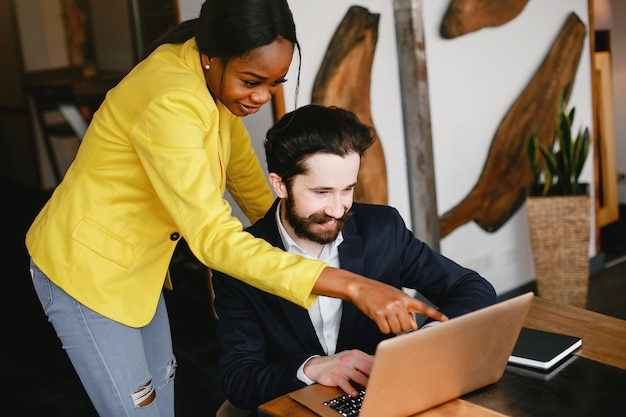 Stylish businessman working in a office with partner