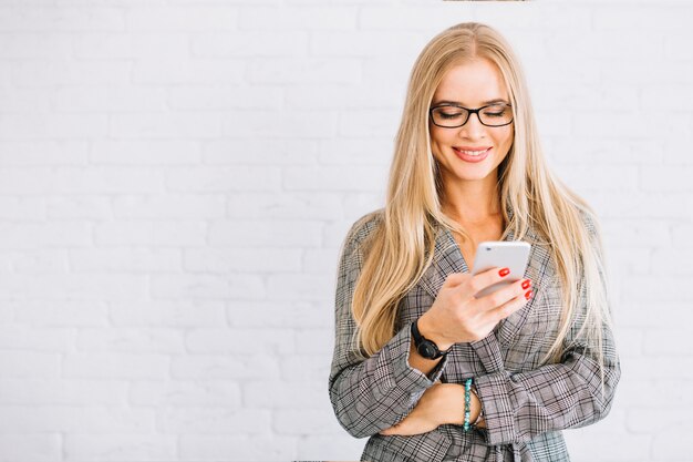 Stylish businesswoman using smartphone