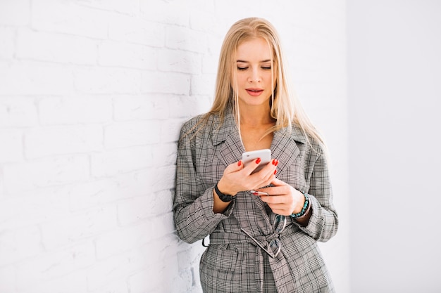 Stylish businesswoman using smartphone