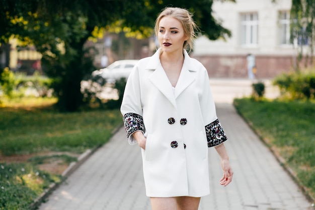 stylish businesswoman walking an posing