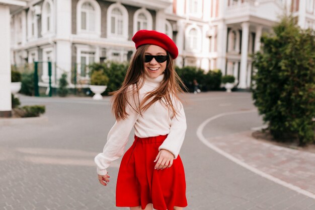 Stylish charming French lady in red skirt and french beret