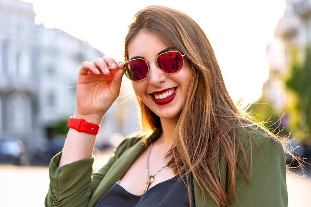 Stylish close up portrait of stylish woman posing near restaurant  cute emotions happy positive faceSunny colors travel mood