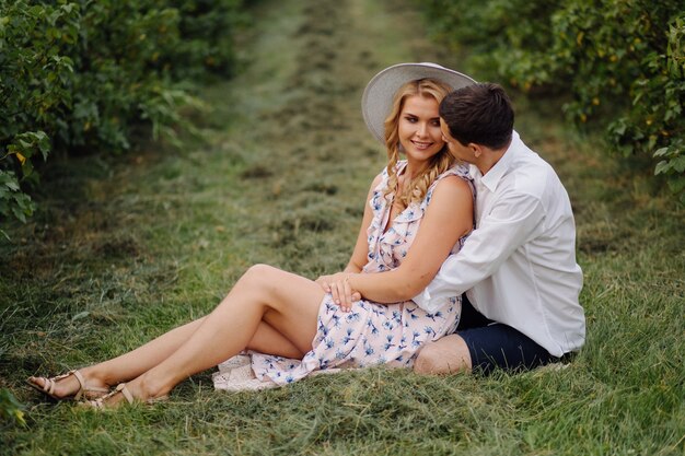 Stylish couple posing in the nature. Love and hugs