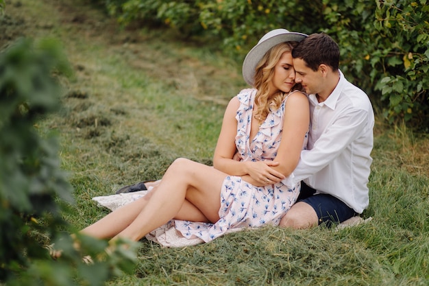 Stylish couple posing in the nature. Love and hugs