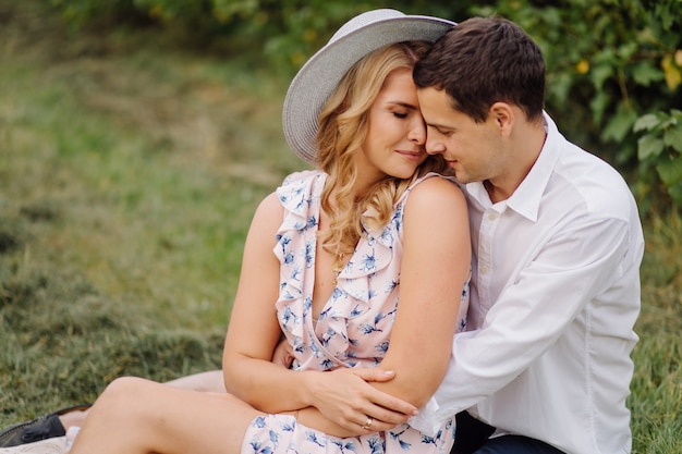 Stylish couple posing in the nature. Love and hugs