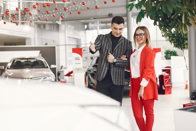 Free Photo stylish and elegant couple in a car salon