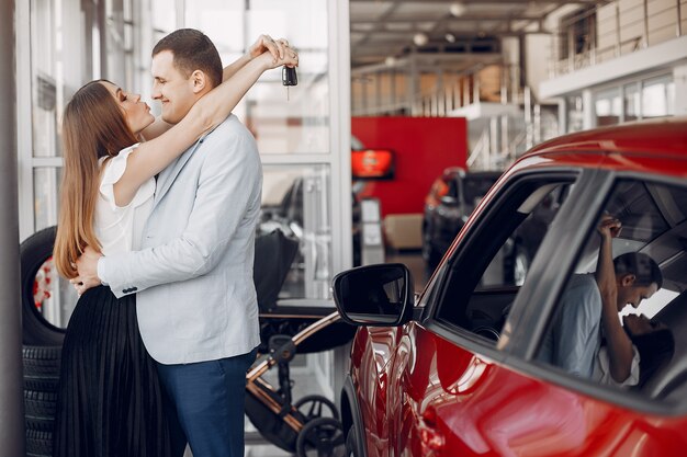 Stylish and elegant family in a car salon