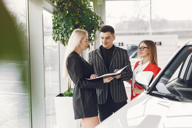 Free Photo stylish and elegant people in a car salon