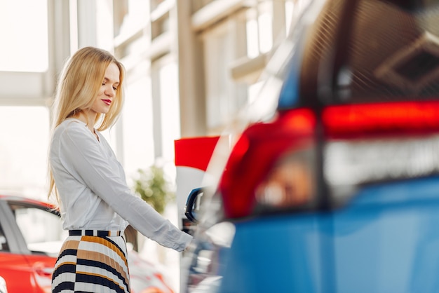 Stylish and elegant woman in a car salon