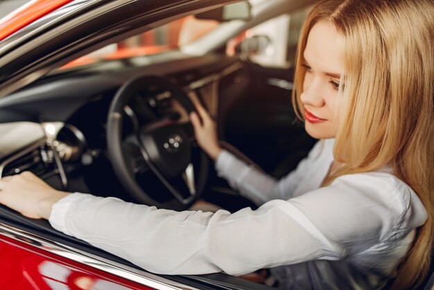 Stylish and elegant woman in a car salon