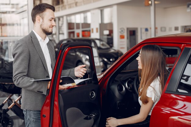 Stylish and elegant woman in a car salon