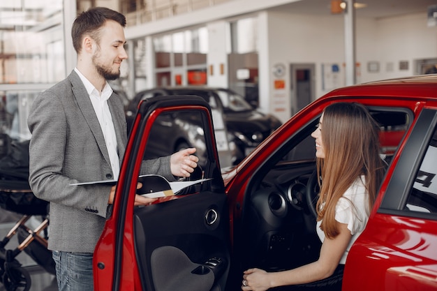 Stylish and elegant woman in a car salon