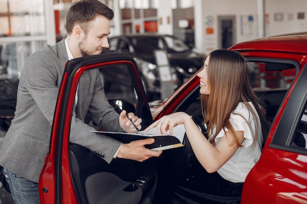 Stylish and elegant woman in a car salon