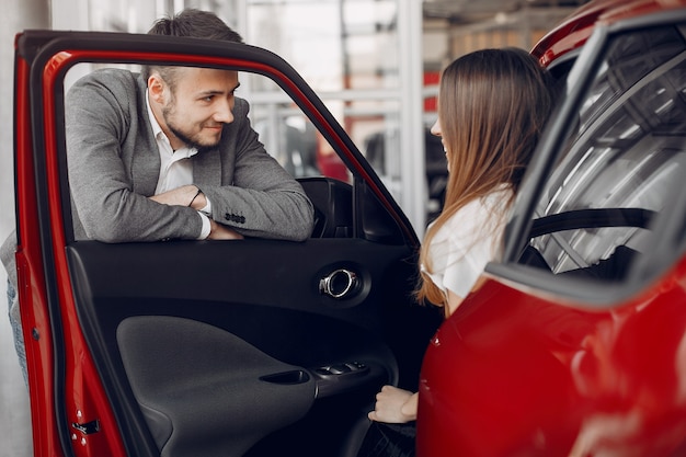 Stylish and elegant woman in a car salon