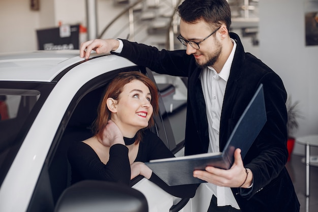 Stylish and elegant woman in a car salon