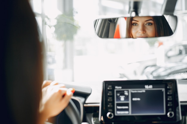 Stylish and elegant woman in a car salon