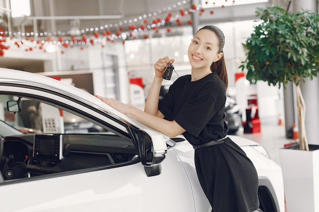 Stylish and elegant woman in a car salon