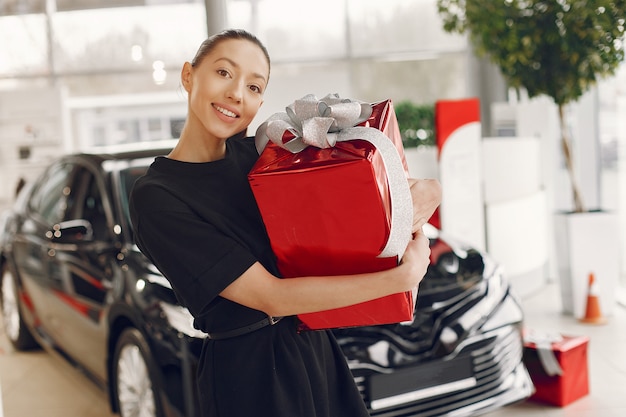 Stylish and elegant woman in a car salon